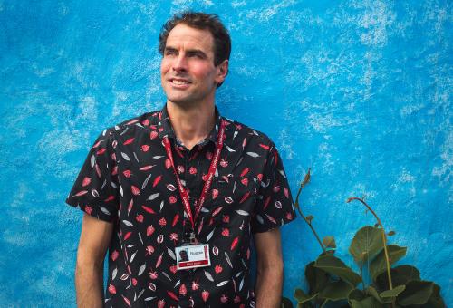 Eden employee Robbie Kirkman standing in front of a blue wall in the Mediterranean Biome